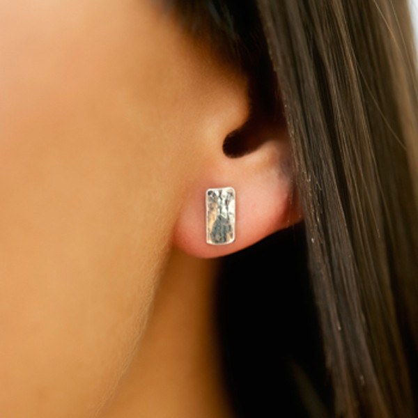 Contemporary silver rectangle stud earrings on model