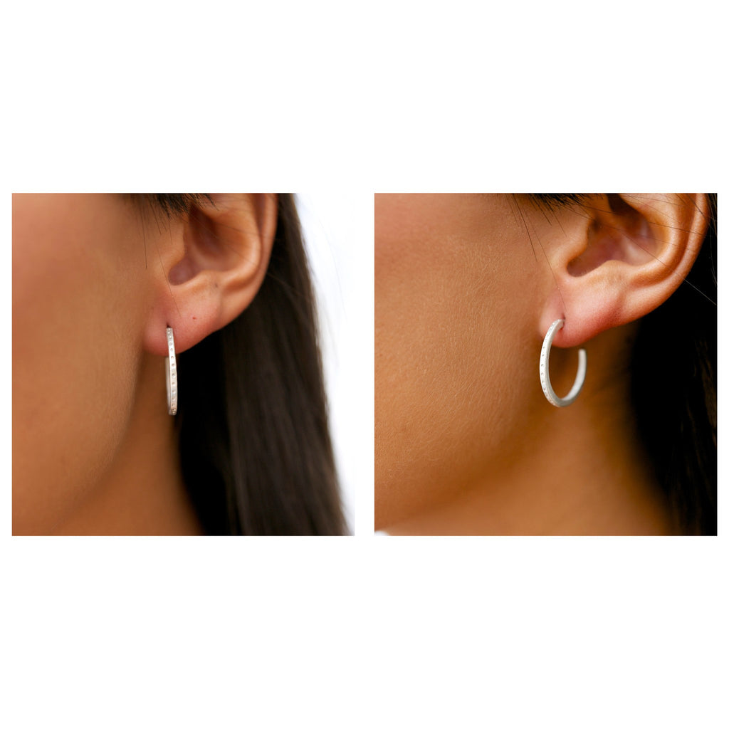 Sterling silver skinny dotty earrings on the ear