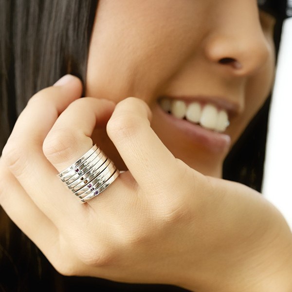 Silver birthstoone stacking rings on model